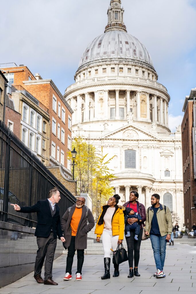 tourists with guide on walking tour of London