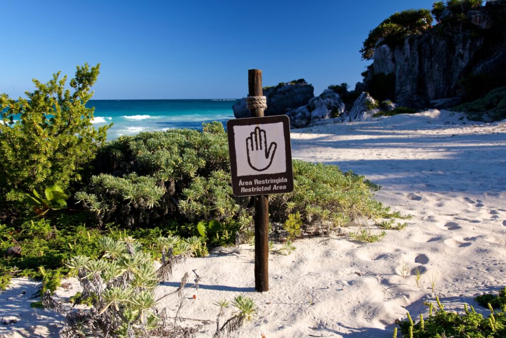 Sign on beach saying 'Restricted Area'