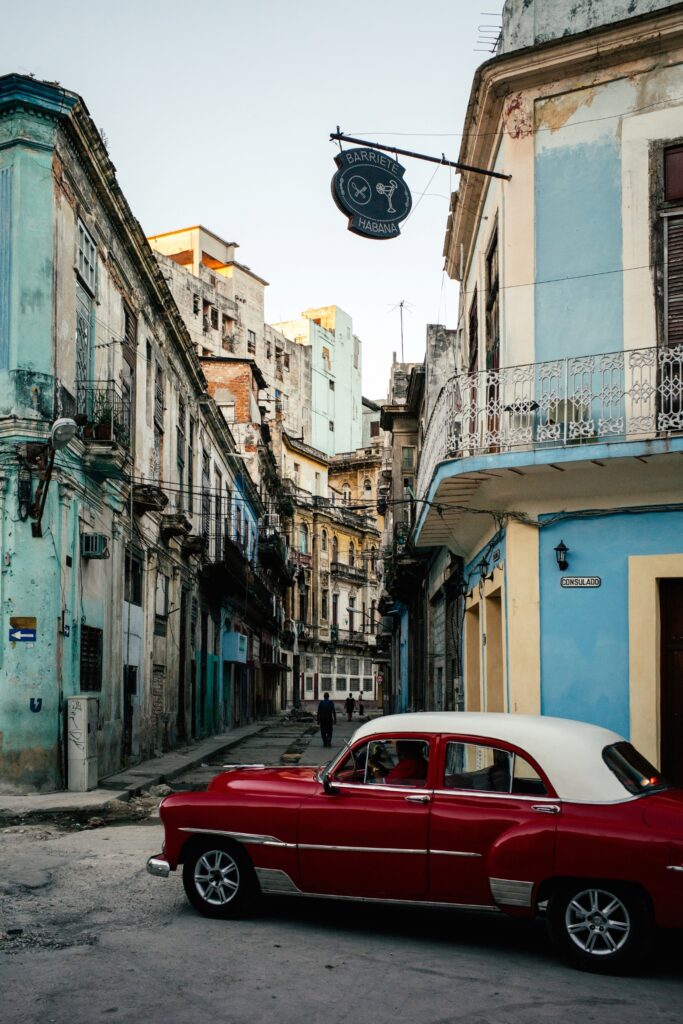 Cuba vintage car on street in front of buildings