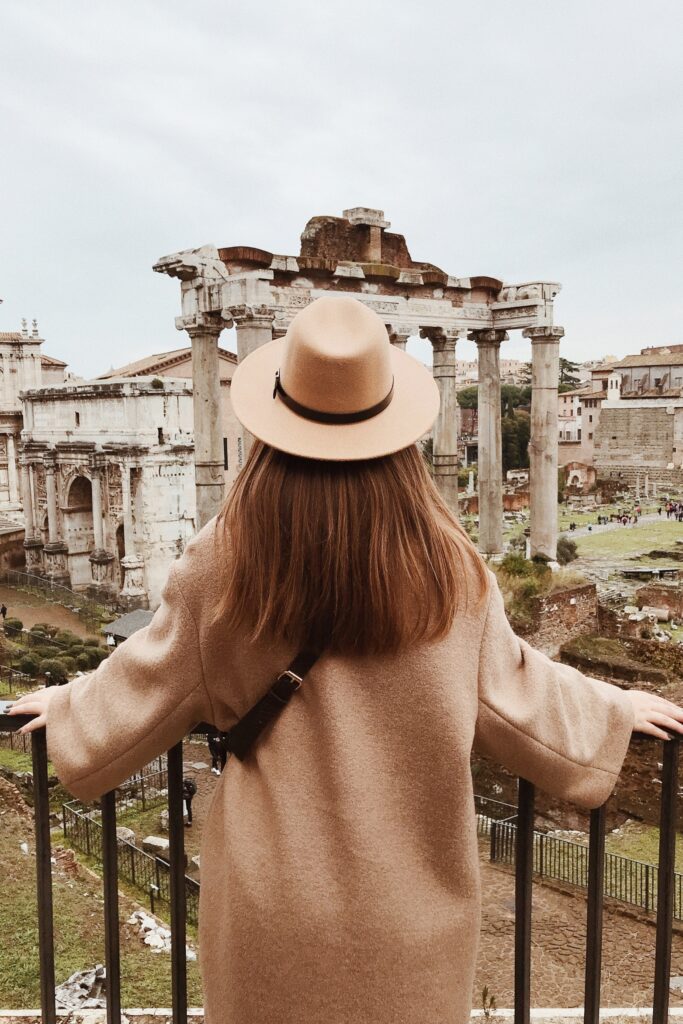 Woman in coat looking at the Fori Romani in Rome