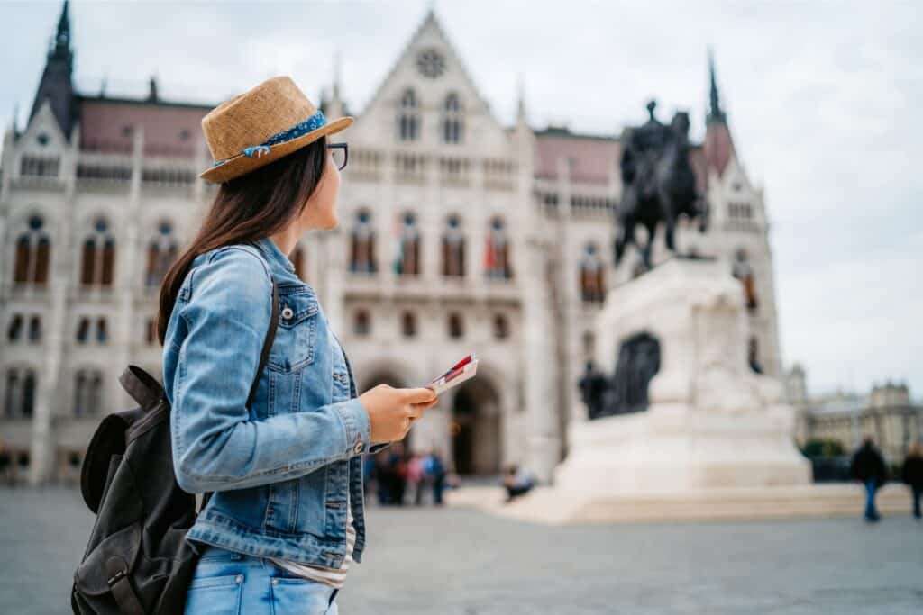 Young woman looking at statue Budapest