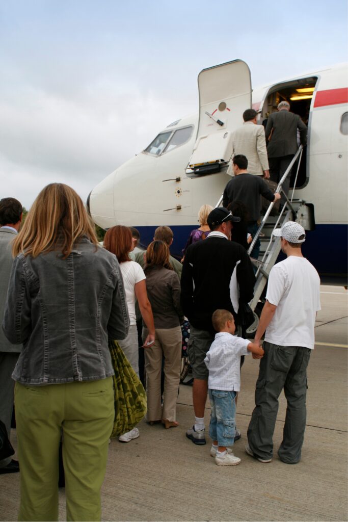 People on tarmac boarding plane