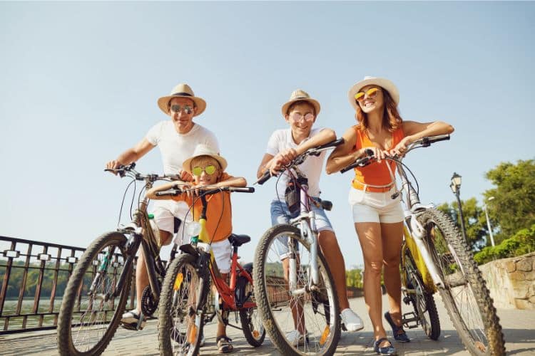 Family on bikes wearing hats and sunglasses