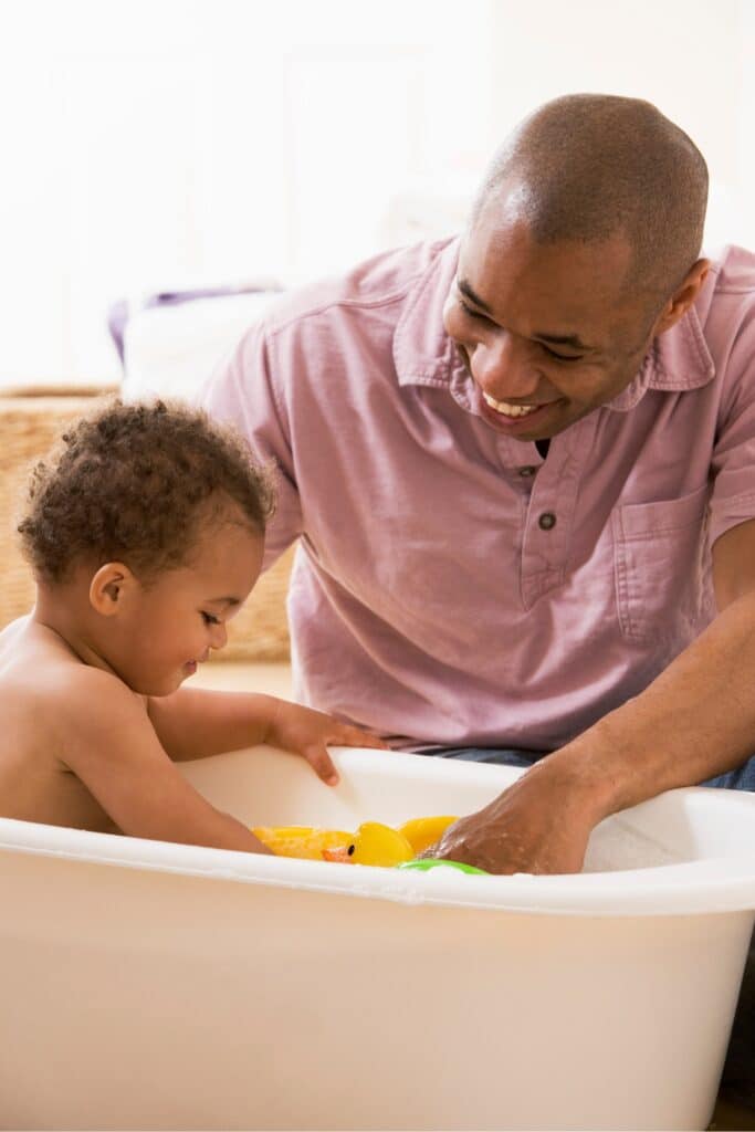 Father giving baby a bath