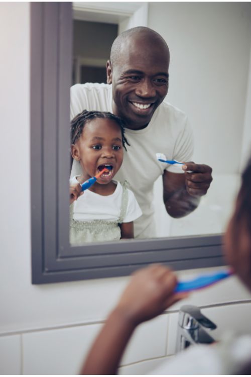 Father and child brushing teeth