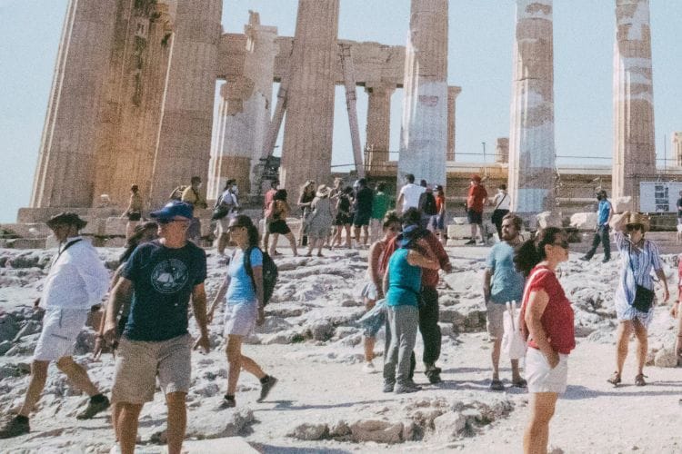 A crowd of tourists in front of the Parthenon
