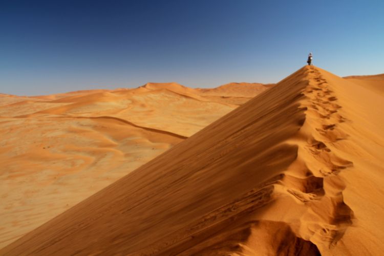 Person on sand dune in Namibia