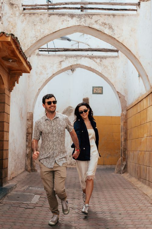A young couple walks down the street holding hands in Casablanca